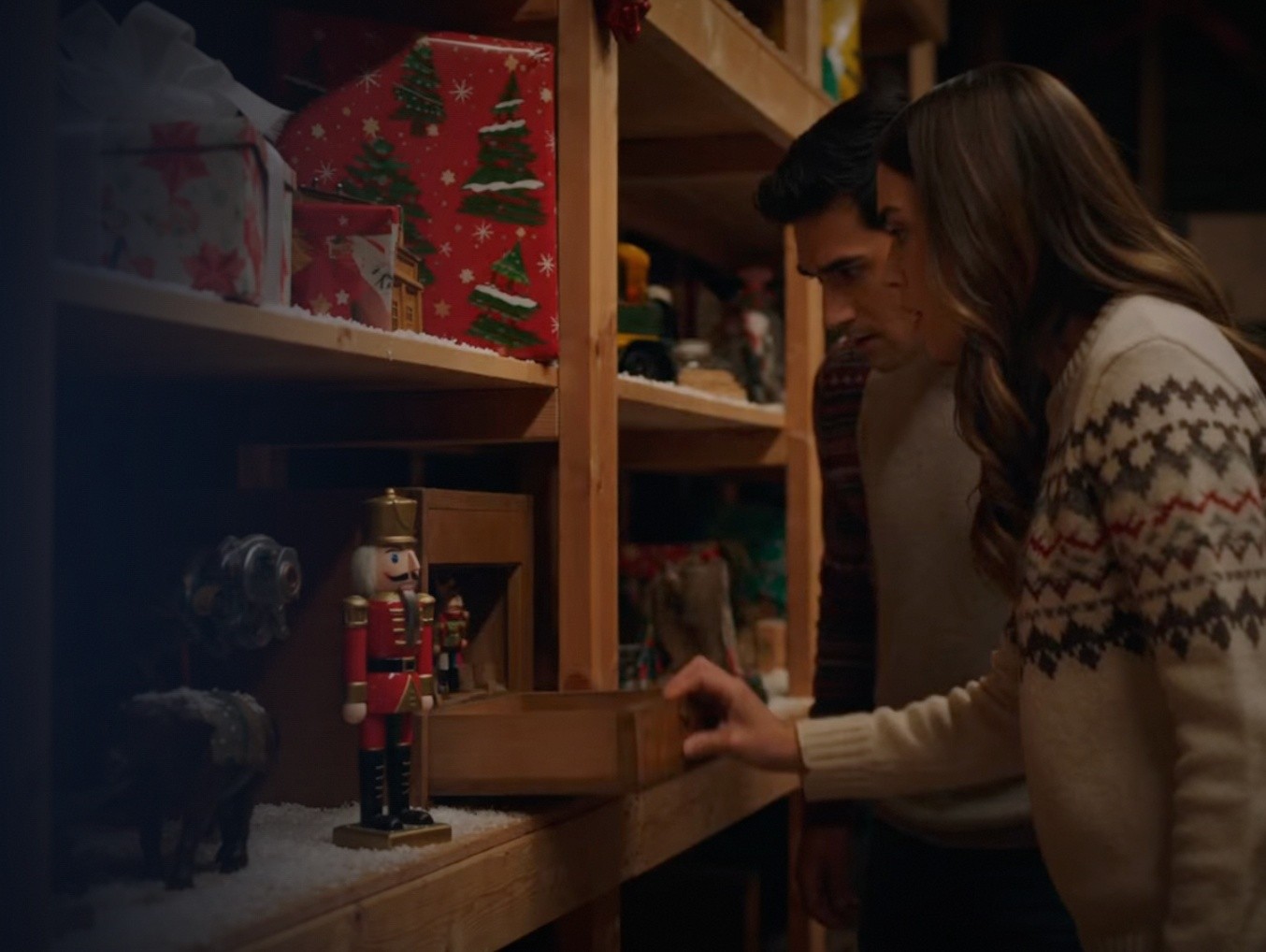 Two people browsing shelves with holiday decorations.
